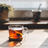 This is a stock photo of tea brewing in front of a sunny window