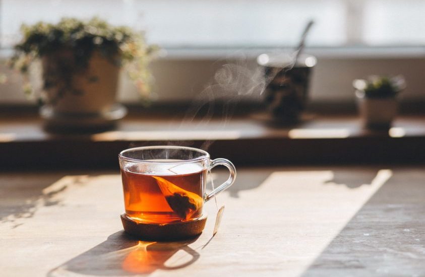 This is a stock photo of tea brewing in front of a sunny window