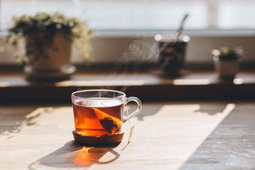 Cup of tea brewing in front of a sunny window